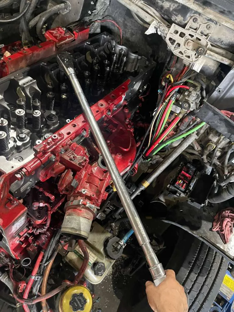 Diesel engine cylinder head service with torque wrench